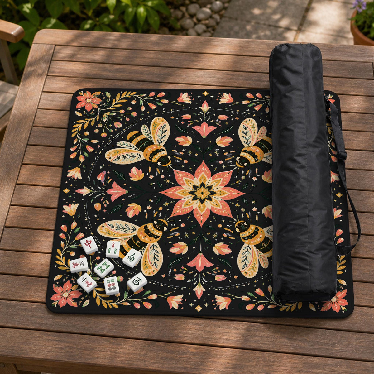 Black mahjong mat with a symmetrical botanical design, coral flowers, golden leaves, and small bees.