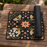 Black mahjong mat with a symmetrical botanical design, coral flowers, golden leaves, and small bees.