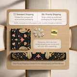 Black mahjong mat with a symmetrical botanical design, coral flowers, golden leaves, and small bees.