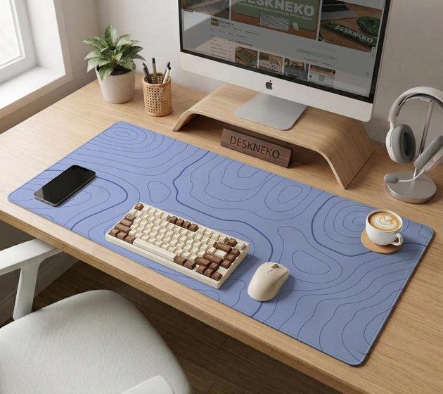A pastel blue mousepad with an abstract topographic contour line pattern.