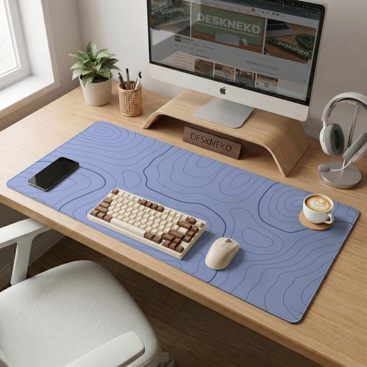 A pastel blue mousepad with an abstract topographic contour line pattern.
