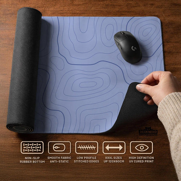 A pastel blue mousepad with an abstract topographic contour line pattern.