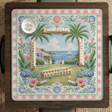 Pastel mahjong mat with a pink gingham border, seashells, hydrangea pots, palm trees, croquet details, and a coastal garden scene.