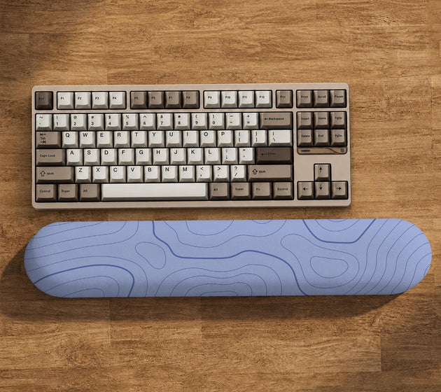 Periwinkle ergonomic mousepad and keyboard wrist rest with a light blue topographic contour line pattern.