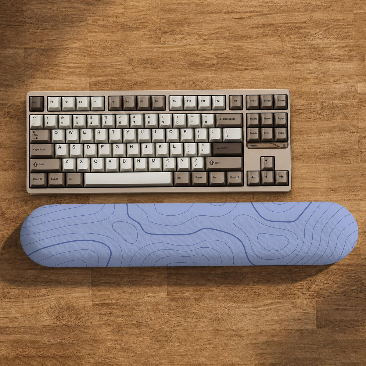 Periwinkle ergonomic mousepad and keyboard wrist rest with a light blue topographic contour line pattern.