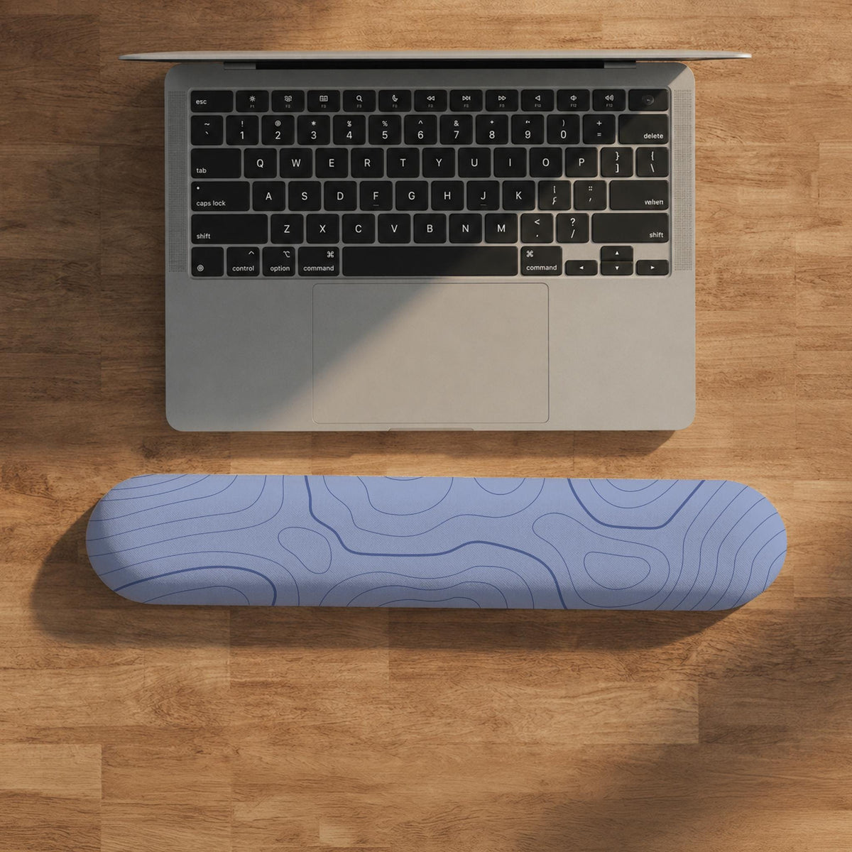 Periwinkle ergonomic mousepad and keyboard wrist rest with a light blue topographic contour line pattern.