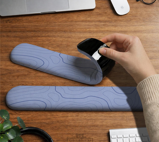 Periwinkle ergonomic mousepad and keyboard wrist rest with a light blue topographic contour line pattern.