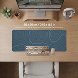 A slate blue desk mat with thin contour line map art on a light background.