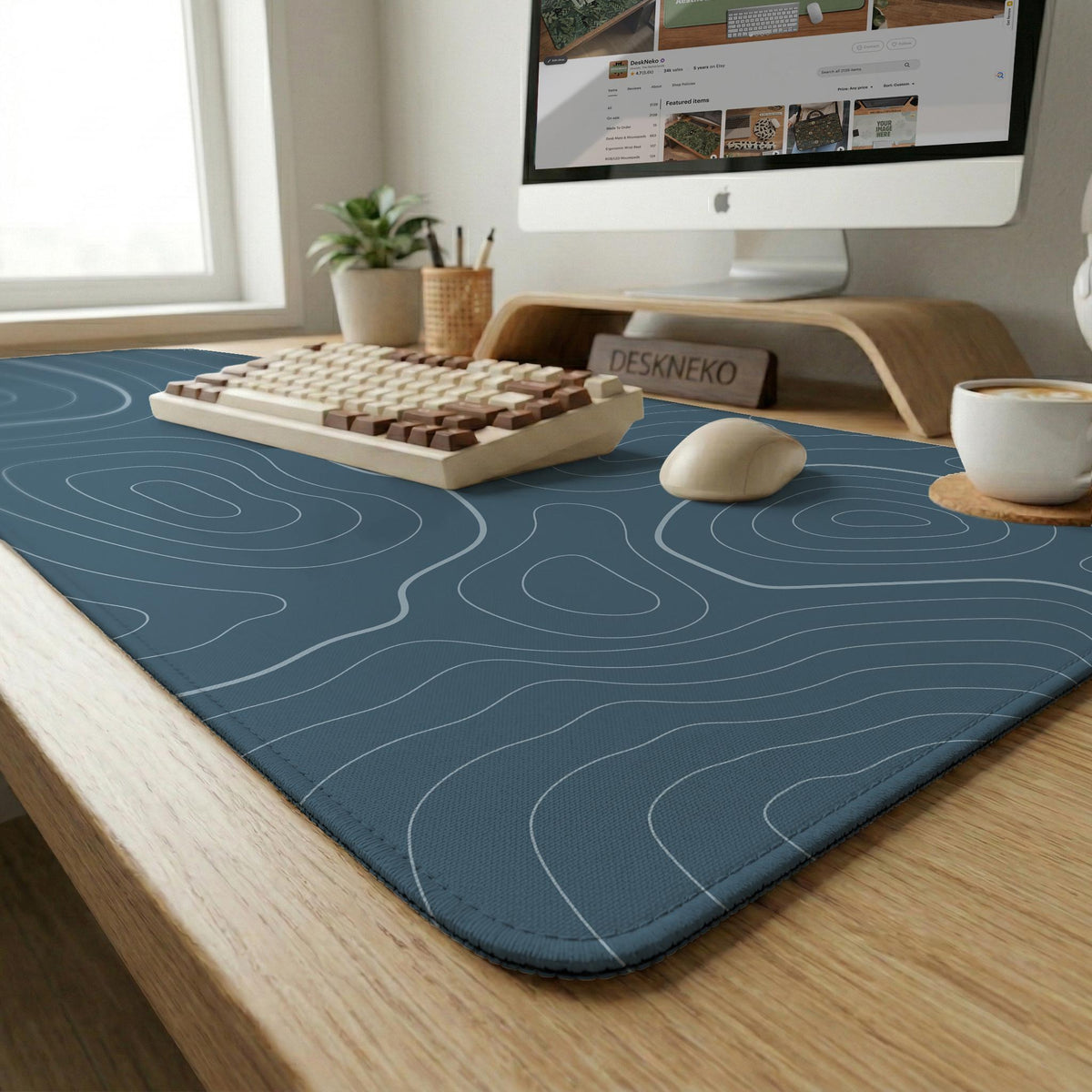 Blue mousepad with a topographic line pattern on a slate background.