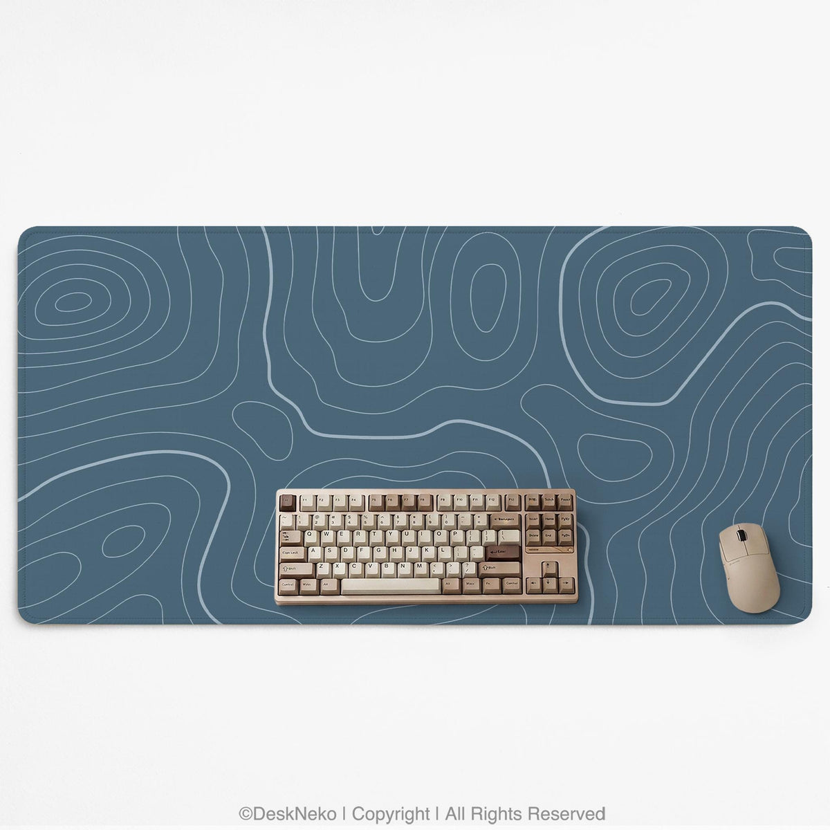 A slate blue desk mat with thin contour line map art on a light background.