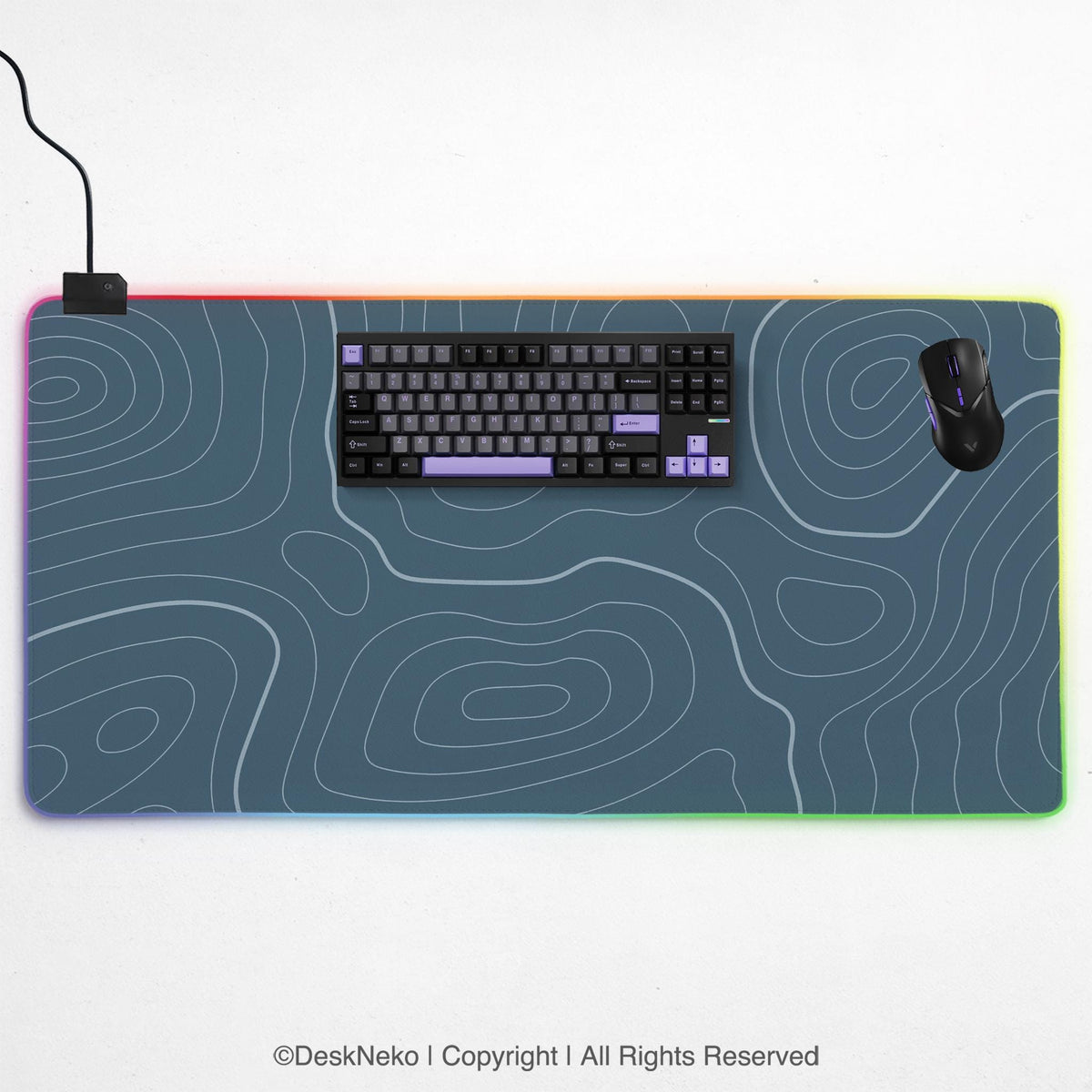 Blue mousepad with a topographic line pattern on a slate background.
