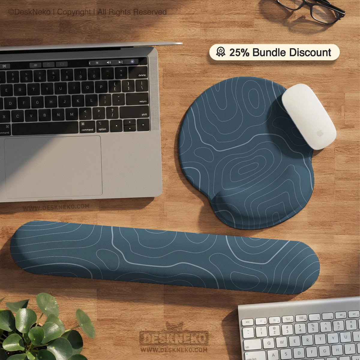 Muted blue desk mat with thin topographic line art pattern shown with matching mousepad and keyboard wrist rest options.