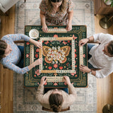 Dark green square mahjong mat with floral branches, small red blossoms, gold line details, and a large moth in the center.
