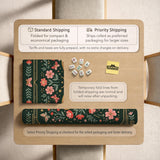 Dark green square mahjong mat with floral branches, small red blossoms, gold line details, and a large moth in the center.