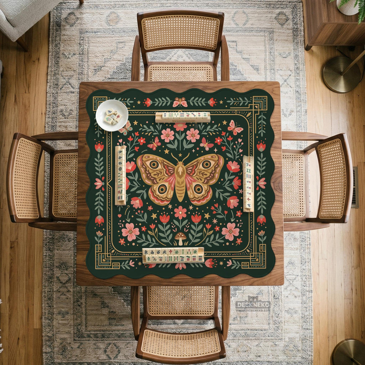 Dark green square mahjong mat with floral branches, small red blossoms, gold line details, and a large moth in the center.