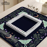 Navy square mahjong mat with a floral border, copper moons, scattered stars, pale moths, and leafy botanical details.