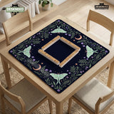 Navy square mahjong mat with a floral border, copper moons, scattered stars, pale moths, and leafy botanical details.