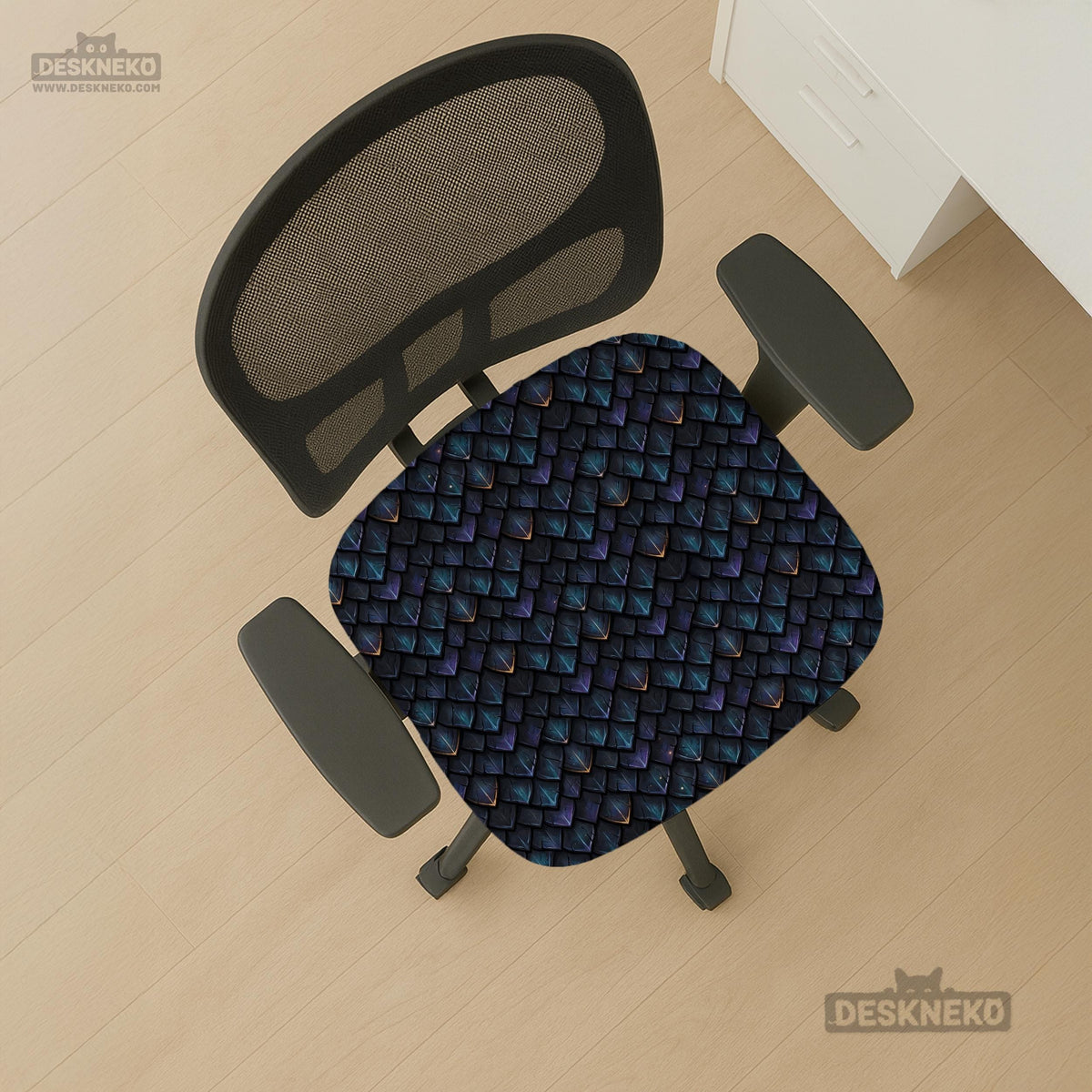 An indigo desk chair cover with a dragon scale pattern in blue, navy, purple, and copper tones, shown as a stretch slipcover with coverage options.