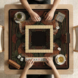 Black square mahjong mat with mirrored tiger faces, bamboo, dark tropical leaves, ornate border details, and orange accents.