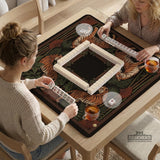 Black square mahjong mat with mirrored tiger faces, bamboo, dark tropical leaves, ornate border details, and orange accents.