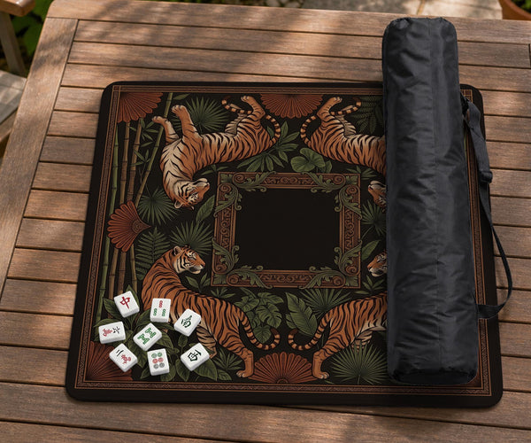 Black square mahjong mat with mirrored tiger faces, bamboo, dark tropical leaves, ornate border details, and orange accents.