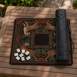 Black square mahjong mat with mirrored tiger faces, bamboo, dark tropical leaves, ornate border details, and orange accents.
