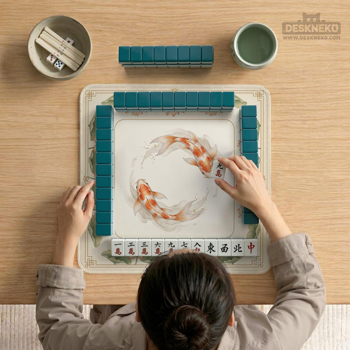 Ivory square mahjong mat with watercolor koi fish, lotus flowers, peach blossoms, sage leaves, and a thin gold border.