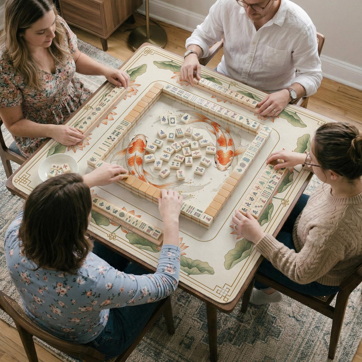 Ivory square mahjong mat with watercolor koi fish, lotus flowers, peach blossoms, sage leaves, and a thin gold border.