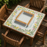 Square yellow mahjong mat with a citrus garden border, green vines, pink blossoms, aqua accents, and a plain center play area.