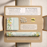 Square yellow mahjong mat with a citrus garden border, green vines, pink blossoms, aqua accents, and a plain center play area.