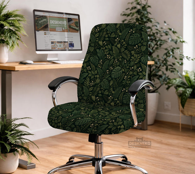 Forest green chair cover with a tropical leaf pattern featuring monstera leaves and small cream flowers.