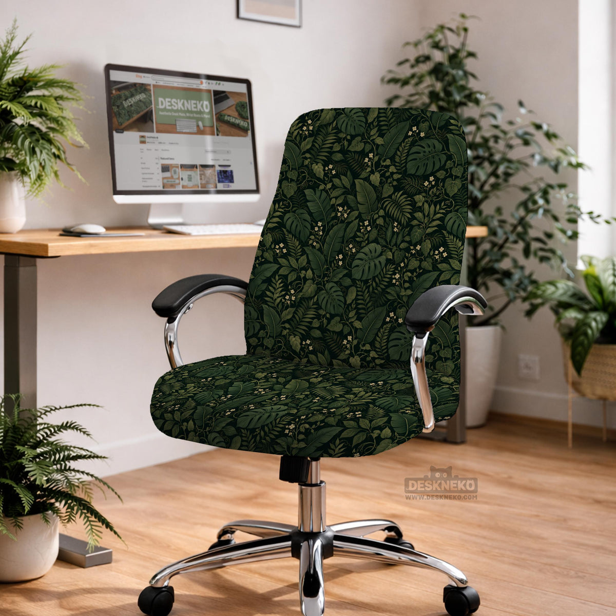 Forest green chair cover with a tropical leaf pattern featuring monstera leaves and small cream flowers.