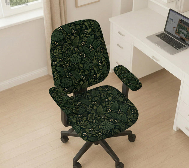 Forest green chair cover with a tropical leaf pattern featuring monstera leaves and small cream flowers.