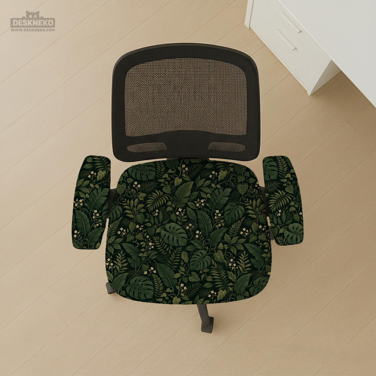 Forest green chair cover with a tropical leaf pattern featuring monstera leaves and small cream flowers.