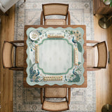 Teal square mahjong mat with peacock feathers, soft floral pattern, tassel details, and printed rule guide text in the center.