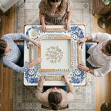 Blue and white square mahjong mat with lucky cat artwork, floral chinoiserie pattern, tile icons, and a rule guide layout.