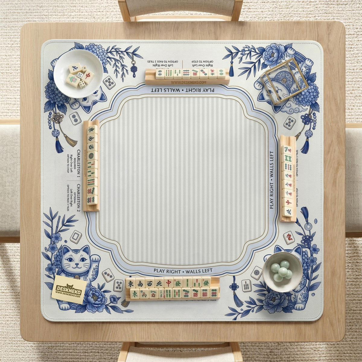 Blue and white square mahjong mat with lucky cat artwork, floral chinoiserie pattern, tile icons, and a rule guide layout.