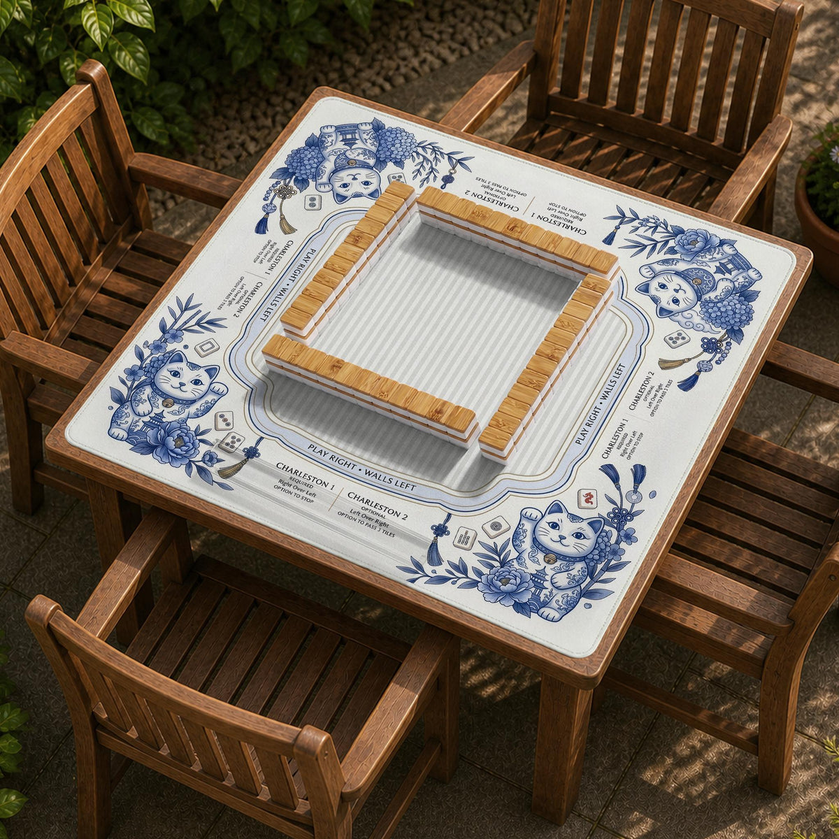 Blue and white square mahjong mat with lucky cat artwork, floral chinoiserie pattern, tile icons, and a rule guide layout.