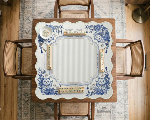 Blue and white square mahjong mat with lucky cat artwork, floral chinoiserie pattern, tile icons, and a rule guide layout.