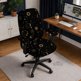 Black chair cover with gold moons, suns, stars, constellations, and line art printed across the fabric.