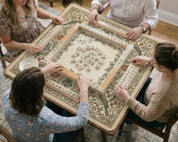 Square mahjong table mat with vintage bird artwork, floral border detail, and sage green, cream, muted blue, and terracotta tones.