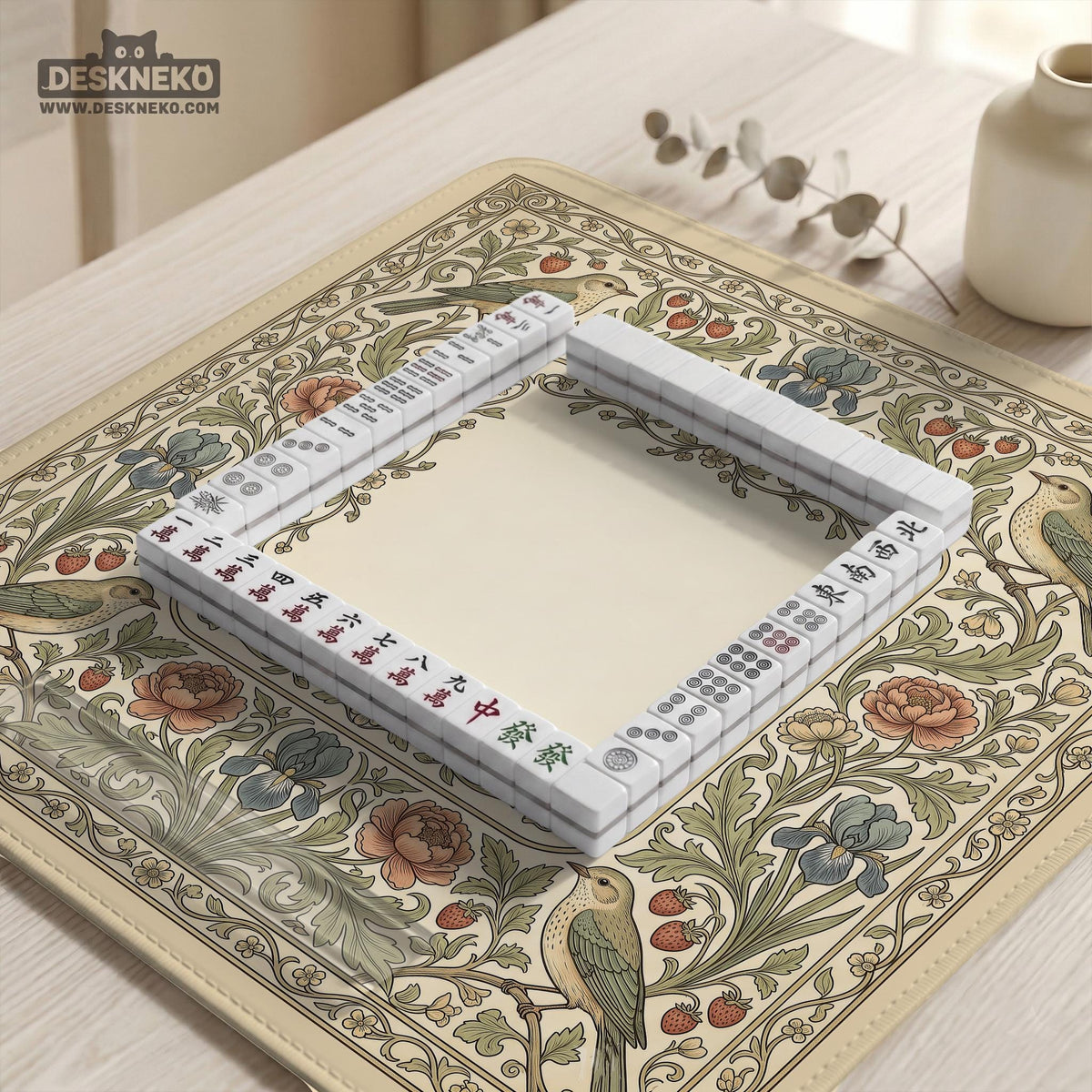 Square mahjong table mat with vintage bird artwork, floral border detail, and sage green, cream, muted blue, and terracotta tones.