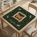 Dark botanical mahjong table mat with a floral border, large moth and butterfly design in the center, gold corner frame, and printed rules layout around the edge.
