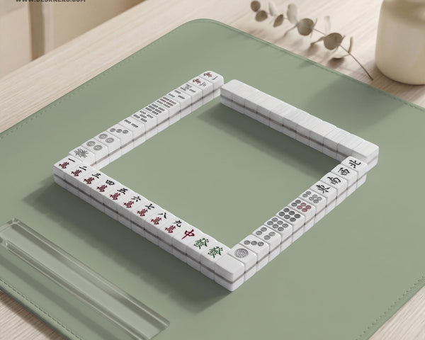 A plain light sage green square mahjong mat with a smooth solid-color surface.