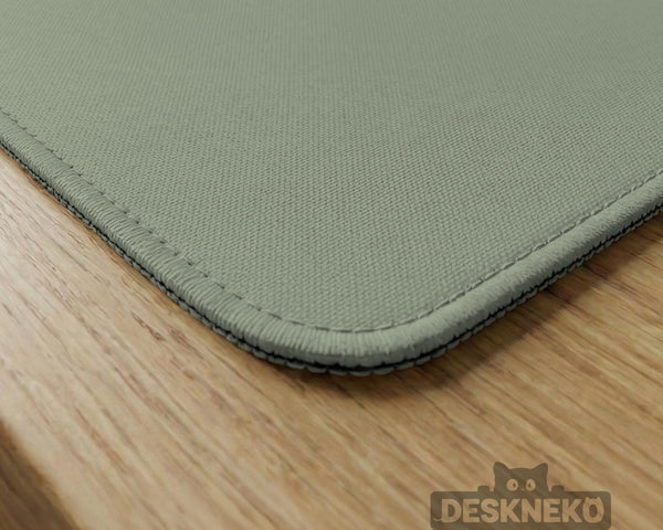 A plain light sage green square mahjong mat with a smooth solid-color surface.