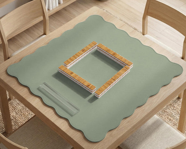 A plain light sage green square mahjong mat with a smooth solid-color surface.