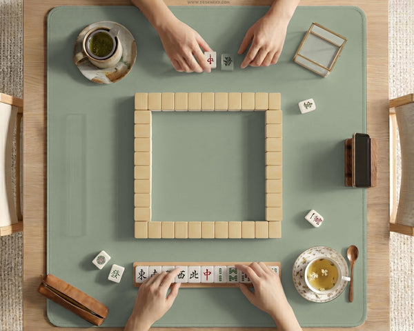 A plain light sage green square mahjong mat with a smooth solid-color surface.