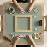 A plain light sage green square mahjong mat with a smooth solid-color surface.