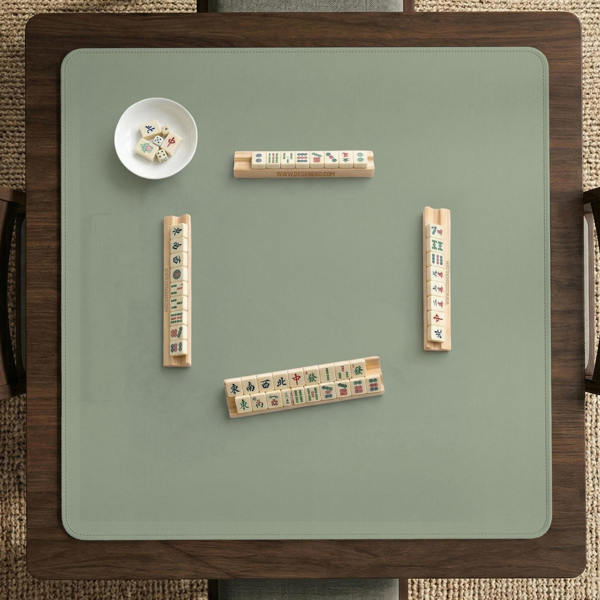 A plain light sage green square mahjong mat with a smooth solid-color surface.