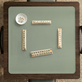 A plain light sage green square mahjong mat with a smooth solid-color surface.